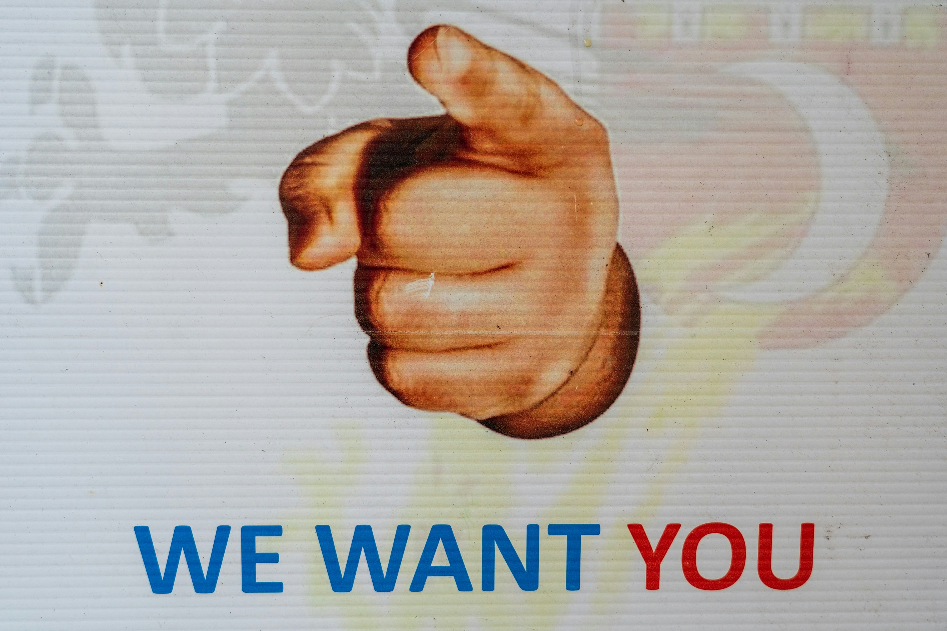 A vintage 'We Want You' recruitment poster with a pointing hand, used to invite volunteers to help govern Acceptable Ads standards